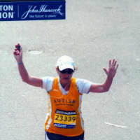 <p>Michele Lawton of Ossining crosses the finish line at the Boston Marathon in 2010.</p>