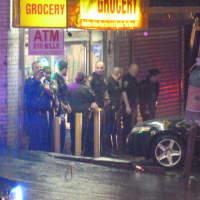 <p>Norwalk police officers search for evidence from a shooting on West Cedar Street on Wednesday night.</p>