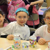 <p>Logan Goodman, Jordana Greenspan and Ashley Podziba decorate donation containers as part of &quot;Mitzvah Day.&quot;</p>