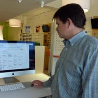 <p>Westport resident Mark Agnew, owner of Eyeglasses.com, which opened its first retail store in Westport recently, shows off the store&#x27;s virtual inventory.</p>