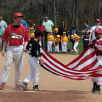 <p>Players unveil the flag for the Pledge of Allegiance.</p>