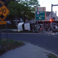 <p>A garbage truck is in the road on East Avenue at the I-95 entrance after rolling over early Thursday morning in Norwalk.</p>