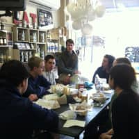 <p>Byram Hills students discuss the farm-to-table movement with Table co-owner Peter Menzies. </p>