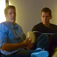 <p>Entrepreneurs Tyler, left, and Cameron Winklevoss speak to a group of businesspeople at a lecture in Greenwich on Thursday.</p>