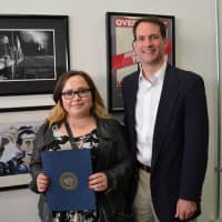 <p>Fairfield Warde student Shannon Magnaldi poses with U.S. Rep. Jim Himes and her award-winning photo, &quot;Off-Peak.&quot;</p>