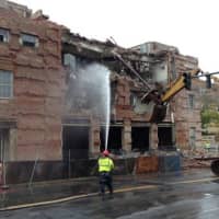 <p>Construction crews demolish the old central fire station on Wednesday to make way for the new $20 million station.</p>