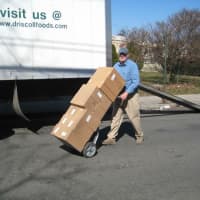 <p>Larchmont Mamaroneck Hunger Task Force volunteers unload donated food items.</p>
