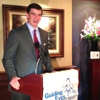 <p>Kate Katulak, a Guiding Eyes graduate, listens on as Eli Manning talks about the Yorktown Heights organization&#x27;s annual golf classic.</p>