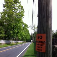 <p>No Parking signs are posted on poles on both sides of the road leading up to the Greenwich Polo Club. </p>