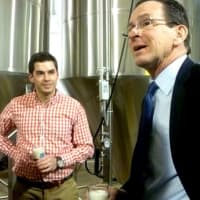 <p>Gov. Dannel Malloy tries a fresh glass of Half Full Brewery&#x27;s Bright Ale with Owner Conor Horrigan in Stamford in March.</p>