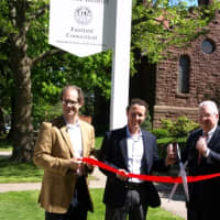 <p>From left: Pete Petron and John Miller of the Old Post Road Area Association, First Selectman Michael Tetreau and Meri Erickson of the Fairfield Museum cut the ribbon on new signs commemorating a historic district.</p>