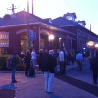 <p>Stranded commuters crowd the parking lot at the South Norwalk train station after service was suspended.</p>