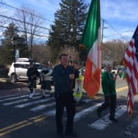<p>A marcher carries the Irish flag in the St. Patrick&#x27;s Day parade in New Fairfield.</p>