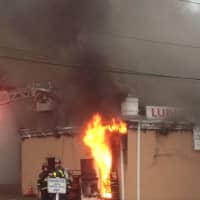<p>Flames can be seen at the Ludlow Shopping Centre at Roger Square in East Norwalk on Thursday afternoon.</p>