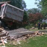 <p>Authorities were trying to determine how to move the truck and how seriously damaged the house was.</p>