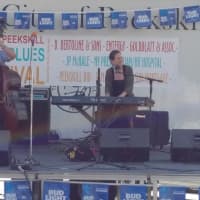 <p>A keyboardist performs on the main stage in Peekskill Saturday.</p>