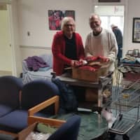 <p>Volunteers Meredith Hovey and John ​Fitzpatrick unpack food supplies at the Jayne Brooks Memorial Food Pantry in Rhinebeck.</p>