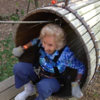 <p>Barbara Stetson, 95, crawls through a tunnel at the The Adventure Parks at The Discovery Museum in Bridgeport.</p>