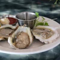 <p>Oysters on a half shell are Pearl at Longshore in Westport.</p>