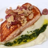 <p>This salmon topped with slivered, toasted almonds is among an array of seafood dishes at Pearl at Longshore in Westport.</p>