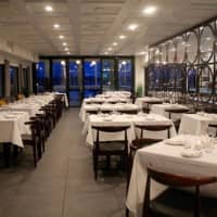 <p>Linen-clad tables line a large dining room at Pearl at Longshore in Westport.</p>