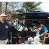 <p>People to People volunteers collect frozen turkeys for the Nanuet food bank.</p>