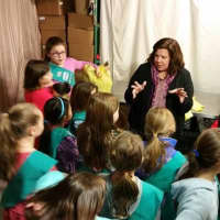<p>People for People executive director Diane Serratore talks to Girl Scouts at the food bank in Nanuet.</p>