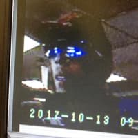 <p>Surveillance footage of one of the suspects in an armed robbery at a Norwalk gas station on Friday</p>