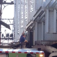 <p>One Star Repair Service towing works to clear the truck from under the train bridge on Washington Street in SoNo.</p>