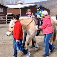 <p>A young client of Pony Power rides at the Three Sisters Farm in Mahwah, N.J.</p>