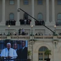 <p>The view from the lawn as Pope Francis sets out and offers his blessing to the crowd. The giant screen made it easy to see. The pope can be seen above on the Speaker&#x27;s Balcony. </p>
