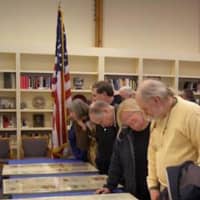<p>Visitors look at documents from the FDR archives at the Franklin D. Roosevelt Presidential Library and Museum in Hyde Park.</p>