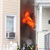 <p>Flames shot through the roof and out the windows of the Summer Street home in Passaic.</p>