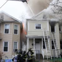 <p>Firefighters kept the blaze from causing more serious damage to the neighboring homes on Summer Street in Passaic.</p>
