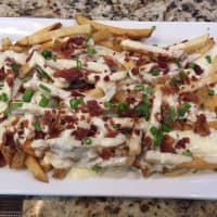 <p>The blue cheese and bacon smothered fries at Barnum Publik House in Bridgeport.</p>