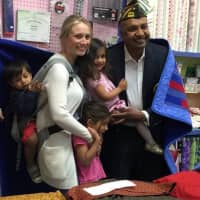 <p>A solider receives his quilt with his wife and young family at Saturday&#x27;s ceremony.</p>