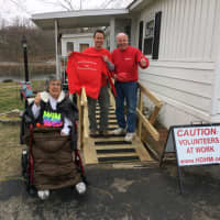 <p>Volunteer Glen Higgins, Handy Dandy Handyman Ministries Founder Peter Brady are shown on the ramp they built with Epy Lawson. Her wheelchair was also donated by the organization.</p>