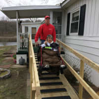 <p>Peter Brady who founded Handy Dandy Handyman Ministries and Epy Lawson try out the newly built ramp at her home in Danbury.</p>