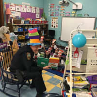 <p>Norwalk Police Lieutenant James Walsh reads to students at Tracey School.</p>