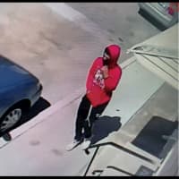 <p>CCTV still of the suspect in a red hoodie.</p>