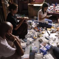 <p>People in Nepal check in medical supplies.</p>