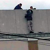 <p>Police secured the worker until firefighters could get him down.</p>