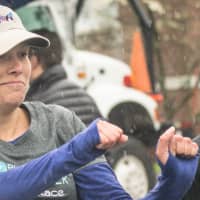 <p>As raindrops fall, a woman gives a fist bump to a fellow runner prior to Sunday&#x27;s Run Like A Mother 5k in Ridgefield.</p>