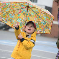 <p>A child keeps dry under an umbrella during Sunday&#x27;s Run Like A Mother 5k race in Ridgefield.</p>