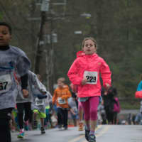 <p>Children run during the kids&#x27; race at the Run Like A Mother event Sunday in Ridgefield.</p>