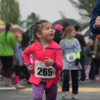<p>A young girl looks up to her mother in the kids&#x27; race at Sunday&#x27;s Run Like A Mother 5k in Ridgefield.</p>
