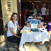 <p>Women wait for guests at a raffle table at A Taste of Rye last month.</p>