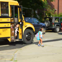 <p>Kids head off the bus and into school on Monday in Danbury. </p>