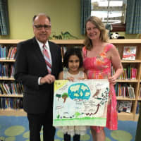 <p>Pictured are Earth Day poster contest winner Saanvi Jaswal, Mayor James Cassella and East Rutherford Library Director Christine Hartigan.</p>