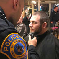 <p>Officer David Scinto shaves fellow Officer Sam Sabin at a shave-off at H Salon in Fairfield. Westport police officers grew their beards to bring awareness to cancer research and the homeless in their community.</p>